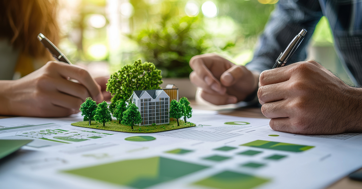 Architects designing sustainable green building evaluating an energy efficiency plan